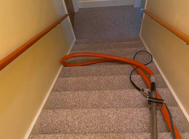 carpet cleaning of some staircases with an orange vacuum cleaner